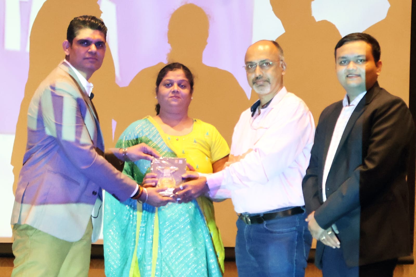 Top performer recognition trophy presented on stage